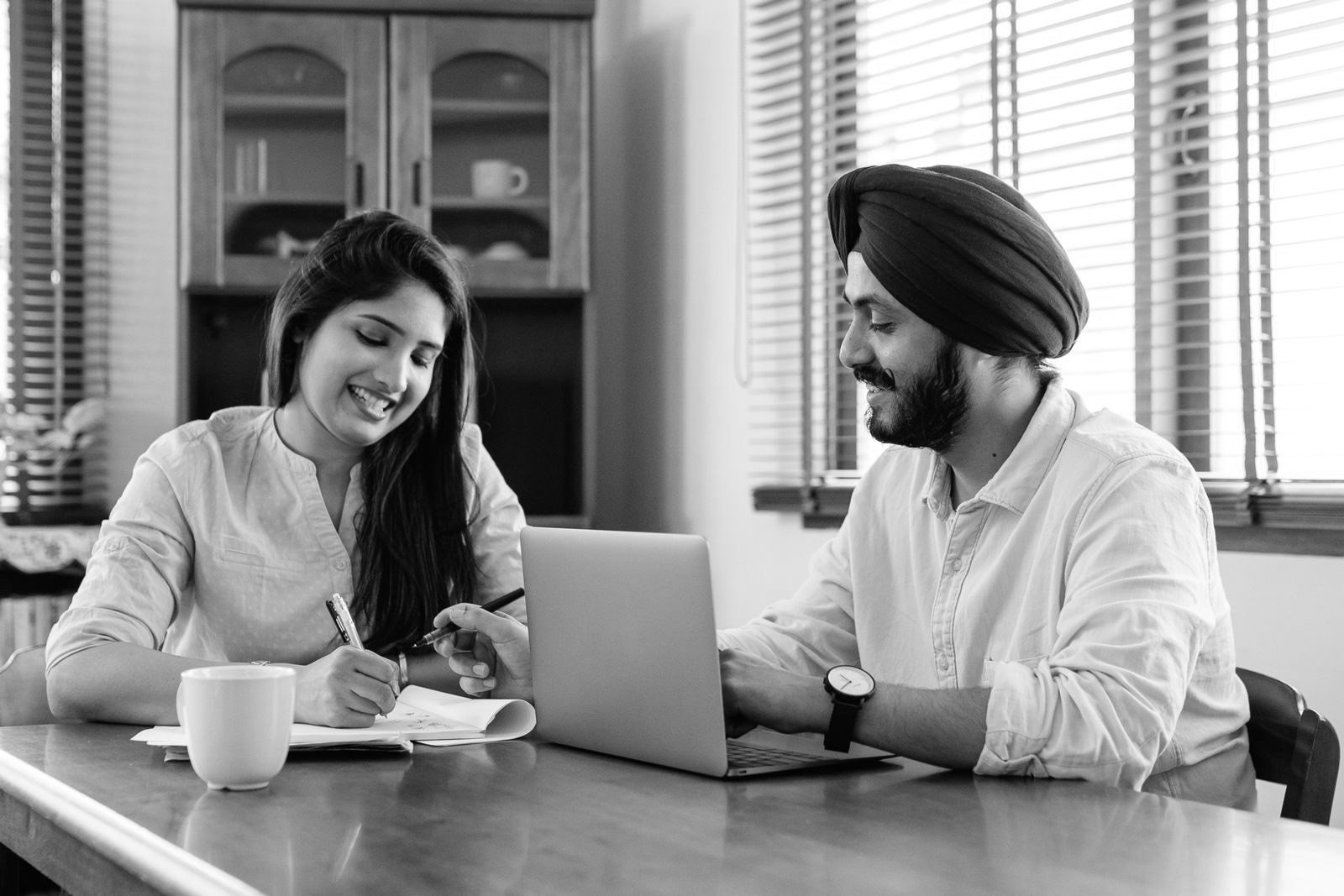 Two colleagues reviewing a plan together at a laptop
