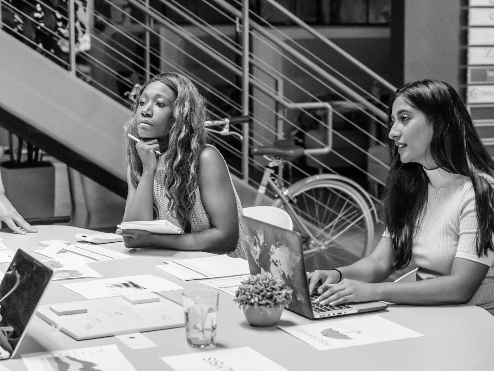 A planning meeting with notes and laptops spread across a table